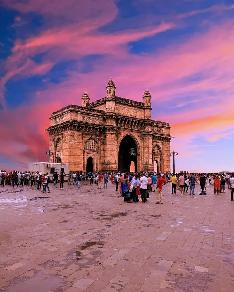 Gateway of India, Mumbai, at sunset with visitors on the promenade
