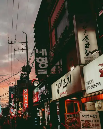 Neon shop signs on a busy Seoul street