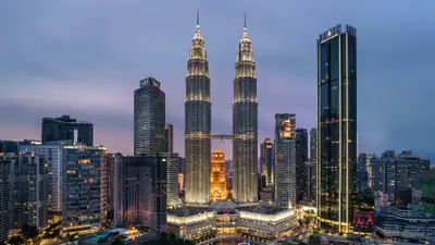 The Petronas Twin Towers and Kuala Lumpur skyline at dusk