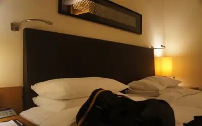 Warmly lit hotel bedroom in Hyderabad